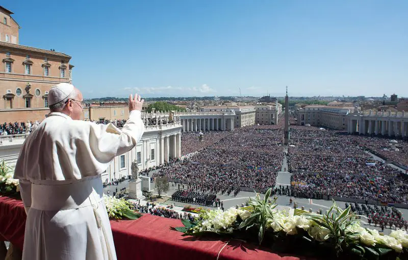 Pope Francis giving speech in front of a huge crowd.